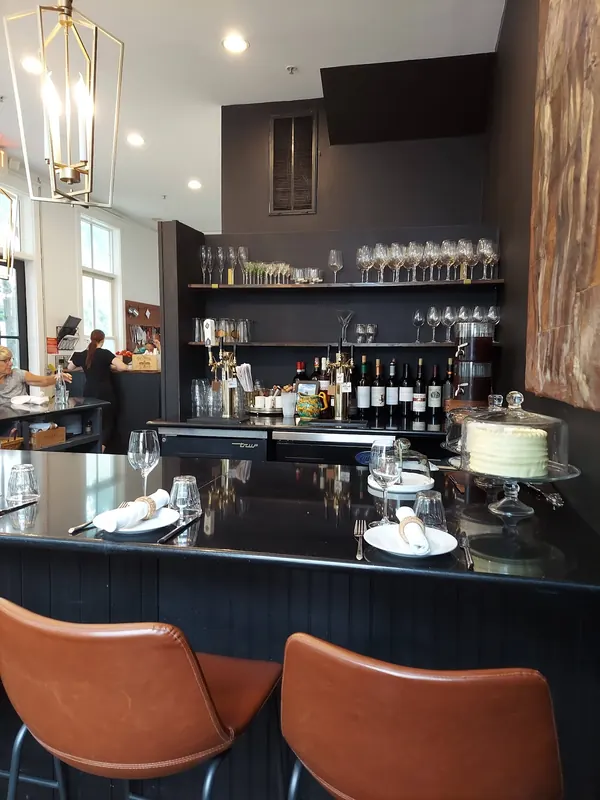 The bar in daylight, bottles lined along the back