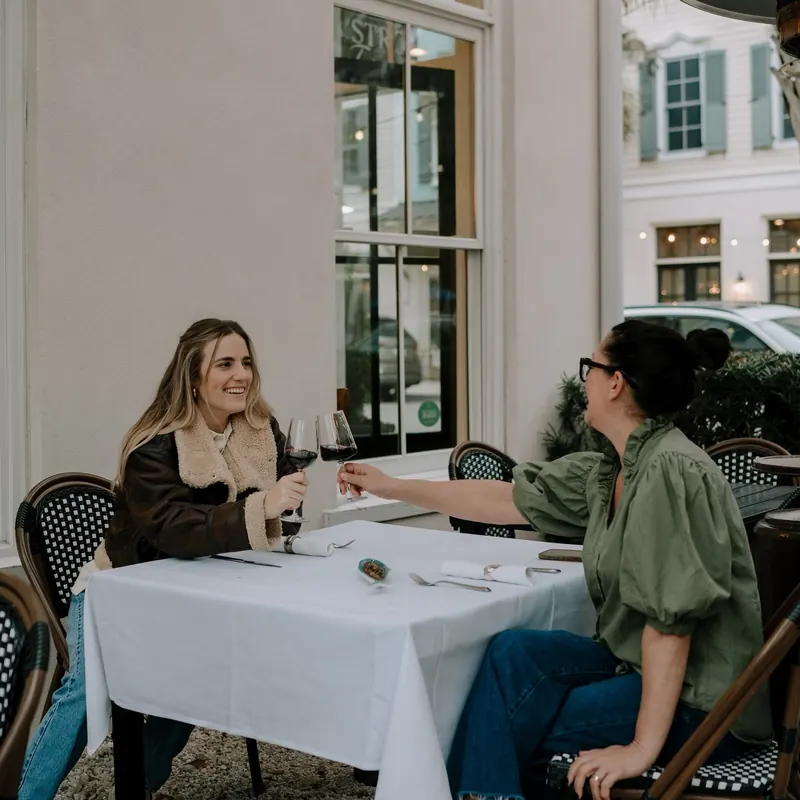 Guests dining together on the patio