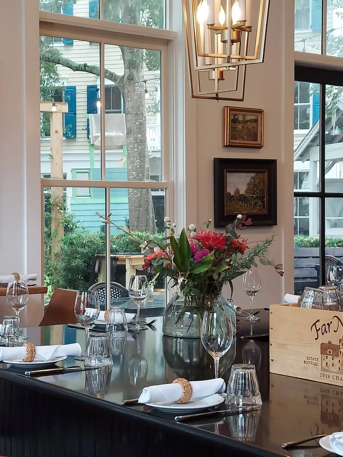 Daylight through tall windows onto the bar and tables inside Bistro Ten