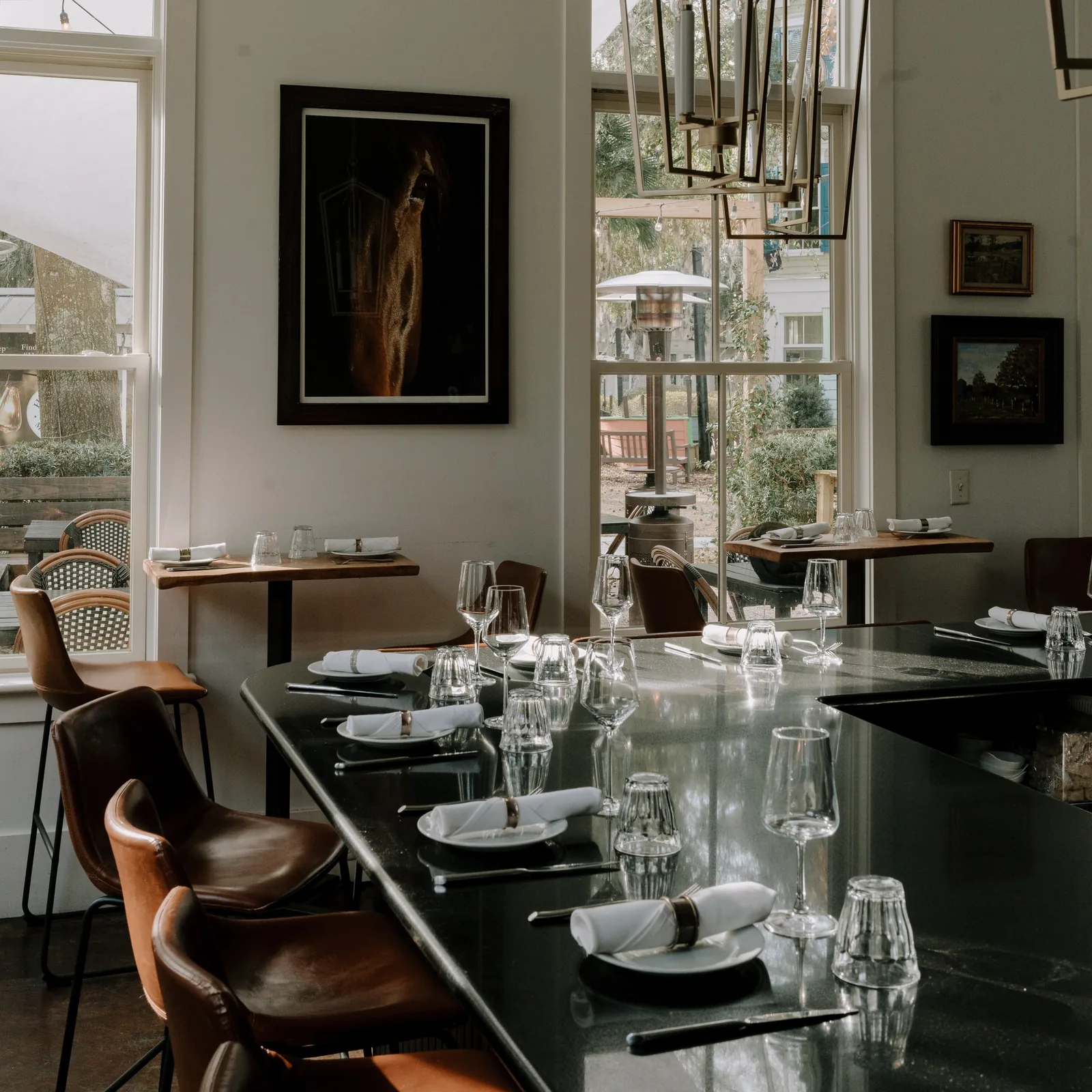 A table set for a party inside the dark dining room at Bistro Ten
