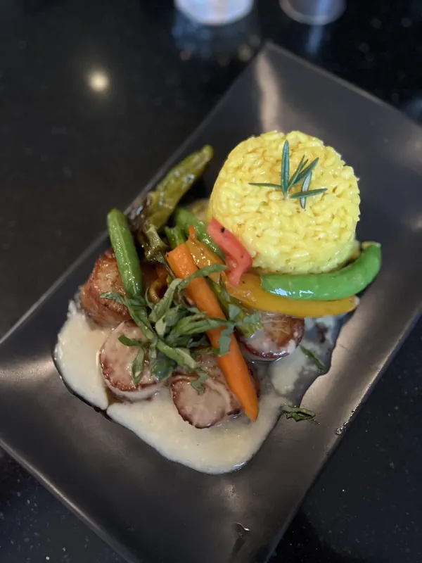 Pork loin medallions with saffron rice and vegetables