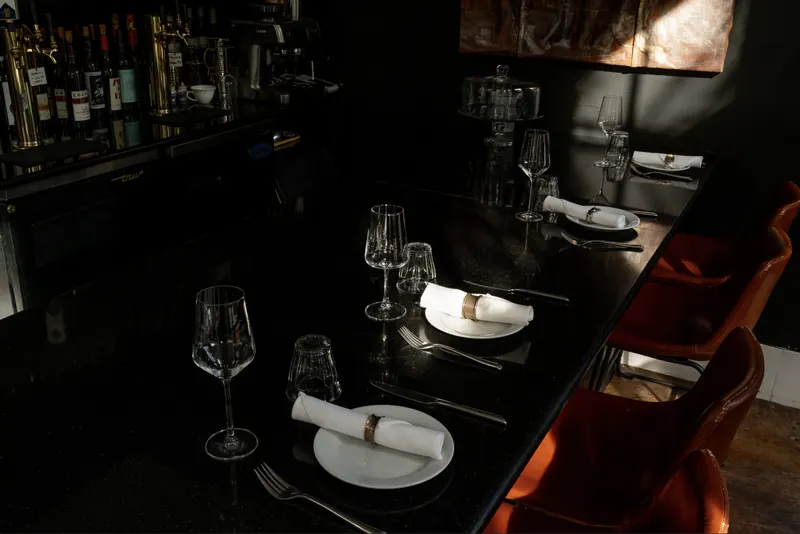 A table set for the evening in the dark dining room